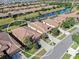 Beautiful view of a home surrounded by community and nature, featuring manicured lawns, canals, and mature trees at 310 Cedar Falls Dr, Apollo Beach, FL 33572