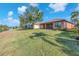 Lush backyard with pond, mature trees, and view of neighboring properties at 310 Cedar Falls Dr, Apollo Beach, FL 33572