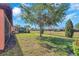 Expansive backyard featuring well-maintained landscaping and pond views at 310 Cedar Falls Dr, Apollo Beach, FL 33572