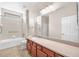 Bathroom includes a shower, tub, and sink with a large mirror at 310 Cedar Falls Dr, Apollo Beach, FL 33572