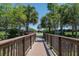 Community walking bridge surrounded by manicured shrubs and trees at 310 Cedar Falls Dr, Apollo Beach, FL 33572