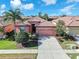 Charming single-story home with a tile roof, well-manicured landscaping, and a two-car garage in a sunny locale at 310 Cedar Falls Dr, Apollo Beach, FL 33572