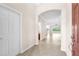 Inviting foyer with tile flooring, arched doorway, and view into the living spaces at 310 Cedar Falls Dr, Apollo Beach, FL 33572