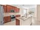 Well-equipped kitchen featuring stainless steel appliances and a functional island at 310 Cedar Falls Dr, Apollo Beach, FL 33572