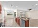 Open kitchen boasts a breakfast bar with stainless steel appliances and ample natural light at 310 Cedar Falls Dr, Apollo Beach, FL 33572