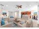 Open-concept living room with modern furnishings, tile floors, and seamless flow to the kitchen at 310 Cedar Falls Dr, Apollo Beach, FL 33572