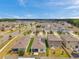 Aerial view of a suburban neighborhood with neatly landscaped yards, and modern homes at 32714 Brooks Hawk Ln, Wesley Chapel, FL 33543