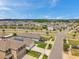 Aerial showcases modern homes in a well-planned community surrounding a serene lake at 32714 Brooks Hawk Ln, Wesley Chapel, FL 33543