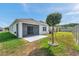 Expansive backyard featuring mature landscaping and a screened lanai at 32714 Brooks Hawk Ln, Wesley Chapel, FL 33543