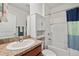 Bathroom features a shower-tub combo, white vanity, and neutral decor at 32714 Brooks Hawk Ln, Wesley Chapel, FL 33543
