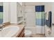 Bathroom features a shower-tub combo, white vanity, and neutral decor at 32714 Brooks Hawk Ln, Wesley Chapel, FL 33543