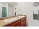 Bathroom featuring double sinks, granite countertops, and decorative towel rack at 32714 Brooks Hawk Ln, Wesley Chapel, FL 33543