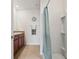 Bathroom boasting granite counters, modern cabinets, and shower with blue curtain at 32714 Brooks Hawk Ln, Wesley Chapel, FL 33543