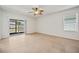 Sunny bedroom with tile flooring and sliding glass doors to backyard at 32714 Brooks Hawk Ln, Wesley Chapel, FL 33543