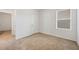 This bedroom has neutral carpet, white walls and a bright window at 32714 Brooks Hawk Ln, Wesley Chapel, FL 33543