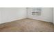 Carpeted bedroom with a large window providing ample natural light at 32714 Brooks Hawk Ln, Wesley Chapel, FL 33543