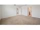 Carpeted bedroom with doors to other rooms and bathroom at 32714 Brooks Hawk Ln, Wesley Chapel, FL 33543