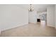 Open dining room with neutral tile flooring and chandelier, flowing into the kitchen area at 32714 Brooks Hawk Ln, Wesley Chapel, FL 33543