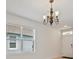 Chandelier and view of the front door with a 'Welcome' transom window, complemented by natural light at 32714 Brooks Hawk Ln, Wesley Chapel, FL 33543