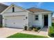 Charming single-Gathering home with a two-car garage, landscaped front yard, and welcoming entrance at 32714 Brooks Hawk Ln, Wesley Chapel, FL 33543