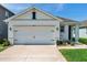 Well-maintained home featuring a two-car garage, manicured lawn, and inviting curb appeal at 32714 Brooks Hawk Ln, Wesley Chapel, FL 33543
