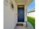 Inviting front entrance with decorative accents and a charming 'Welcome' sign above the dark-colored door at 32714 Brooks Hawk Ln, Wesley Chapel, FL 33543