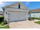 Spacious two-car garage with well-kept landscaping, offering convenience and ample parking at 32714 Brooks Hawk Ln, Wesley Chapel, FL 33543