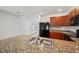Kitchen features stainless steel appliances, granite countertops and tile flooring at 32714 Brooks Hawk Ln, Wesley Chapel, FL 33543