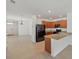Open concept kitchen and living area with tile floors and modern appliances at 32714 Brooks Hawk Ln, Wesley Chapel, FL 33543