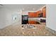 Kitchen features stainless steel appliances, granite countertops and tile flooring at 32714 Brooks Hawk Ln, Wesley Chapel, FL 33543