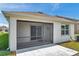 Relaxing screened patio with tiled flooring, providing a comfortable and bug-free outdoor living space at 32714 Brooks Hawk Ln, Wesley Chapel, FL 33543