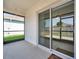 Screened patio features sliding glass doors offering indoor-outdoor flow and views of the fenced backyard at 32714 Brooks Hawk Ln, Wesley Chapel, FL 33543