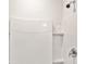 Shower showcasing a white tile surround with built-in shelving and modern fixtures at 32714 Brooks Hawk Ln, Wesley Chapel, FL 33543