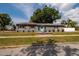 Charming home exterior with gray siding, colorful landscaping, and a well-maintained lawn at 3301 8Th N Ave, St Petersburg, FL 33713