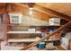 View of an attic space with wood beams, insulation, and available shelf storage at 3505 Tarpon Woods Blvd # K409, Palm Harbor, FL 34685