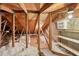 View of attic space with wooden beams, insulation, and plywood flooring for storage at 3505 Tarpon Woods Blvd # K409, Palm Harbor, FL 34685