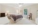 Comfortable bedroom featuring a window with plantation shutters, ceiling fan, and nice furniture at 3505 Tarpon Woods Blvd # K409, Palm Harbor, FL 34685