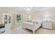 Bright bedroom with white furniture, ceiling fan and a window with plantation shutters overlooking the yard at 3505 Tarpon Woods Blvd # K409, Palm Harbor, FL 34685