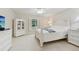 Well-lit bedroom with a bed, white furniture and ceiling fan and a window with plantation shutters at 3505 Tarpon Woods Blvd # K409, Palm Harbor, FL 34685