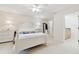 Bright bedroom with a bed, white furniture and ceiling fan and an ensuite bathroom at 3505 Tarpon Woods Blvd # K409, Palm Harbor, FL 34685