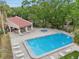 Aerial view of community pool, hot tub, and cabana area with lounge chairs at 3505 Tarpon Woods Blvd # K409, Palm Harbor, FL 34685