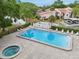 An aerial shot of a community pool with lounge chairs and pristine landscaping at 3505 Tarpon Woods Blvd # K409, Palm Harbor, FL 34685