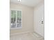 Bright foyer featuring a white door, shuttered window, and neutral tile flooring at 3505 Tarpon Woods Blvd # K409, Palm Harbor, FL 34685
