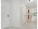 Hallway with white doors and marble flooring leads to the living room at 3505 Tarpon Woods Blvd # K409, Palm Harbor, FL 34685