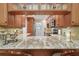 Open kitchen featuring granite countertops, wood cabinets, and stainless steel appliances at 3505 Tarpon Woods Blvd # K409, Palm Harbor, FL 34685