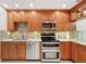 Kitchen boasts wood cabinets, granite countertops, and stainless steel appliances at 3505 Tarpon Woods Blvd # K409, Palm Harbor, FL 34685