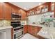 Traditional kitchen with stainless steel appliances, wooden cabinets, and granite countertops at 3505 Tarpon Woods Blvd # K409, Palm Harbor, FL 34685