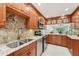 Open concept kitchen with stainless appliances, granite countertops, and wooden cabinets at 3505 Tarpon Woods Blvd # K409, Palm Harbor, FL 34685