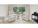 Cozy living room featuring comfortable seating and a large window with a relaxing outdoor view at 3505 Tarpon Woods Blvd # K409, Palm Harbor, FL 34685