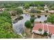 Aerial view of a large pond surrounded by condo units and trees at 3505 Tarpon Woods Blvd # K409, Palm Harbor, FL 34685